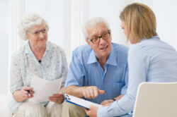 Senior reviewing Medicare dental vision and hearing coverage options with a Medicare broker